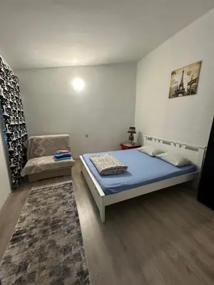 a bedroom with a bed and a chair in it at Apartment Aleksandra in Bar