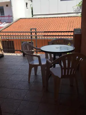 two chairs and a table and chairs on a patio at Apartment Aleksandra in Bar