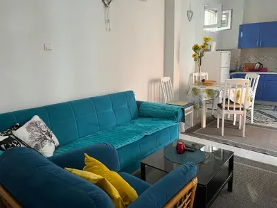 a living room with a blue couch and a table at Apartment Aleksandra in Bar