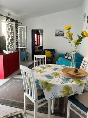 a kitchen with a table with a flowery table cloth at Apartment Aleksandra in Bar