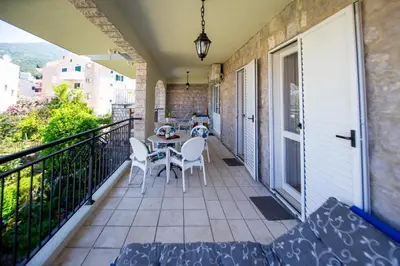 a balcony with a table and chairs on it at Apartment Stanko in Pržno