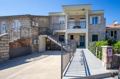 a house with a staircase in front of it at Apartment Stanko in Pržno