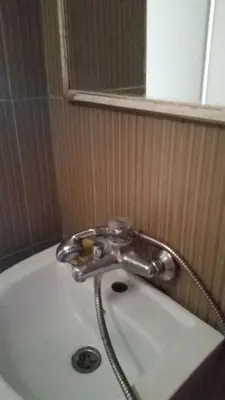 a bath tub with a faucet in a bathroom at Apartment Oaza in Bar