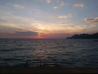 a sunset over a large body of water at Apartment Oaza in Bar