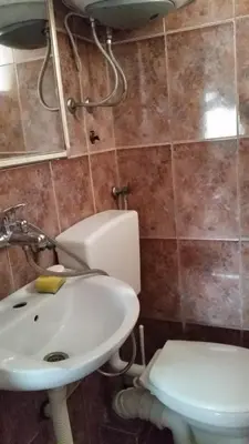 a bathroom with a sink and a toilet at Apartment Oaza in Bar
