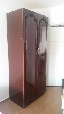 a large wooden cabinet in the corner of a room at Apartment Oaza in Bar