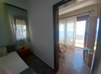 a bedroom with a door open to a room with a window at Marko Apartments in Ulcinj