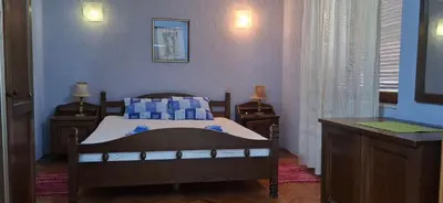 a bedroom with a bed with blue walls and a window at Marko Apartments in Ulcinj