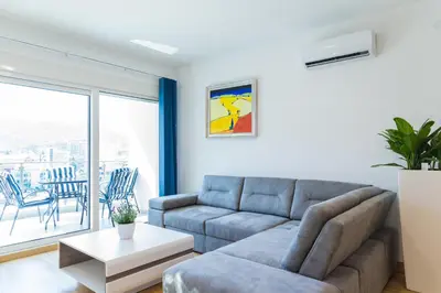 a living room with a couch and a table at Apartment Blue Adriatic in Budva