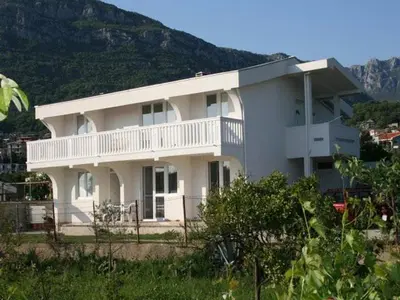 a large white house with a balcony on it at Anika apart in Bar