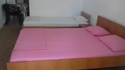 two beds in a room with pink sheets at Anika apart in Bar
