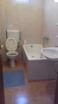 a bathroom with a tub and a toilet and a sink at Anika apart in Bar