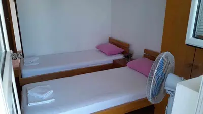 a small room with two benches with pink pillows at Anika apart in Bar