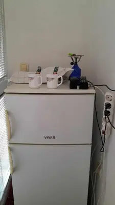 a white refrigerator with two cups on top of it at Anika apart in Bar