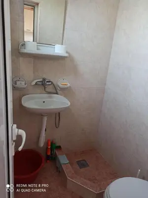 a bathroom with a sink and a toilet at Anika apart in Bar