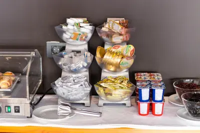 a table topped with bowls of food and snacks at Hotel Ulliri & SPA in Ulcinj