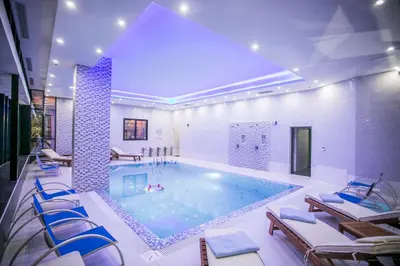 a large swimming pool with chairs in a building at Hotel Ulliri & SPA in Ulcinj