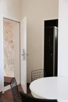 a dining room with a white table and chairs at Lux M & A Apartments in Budva
