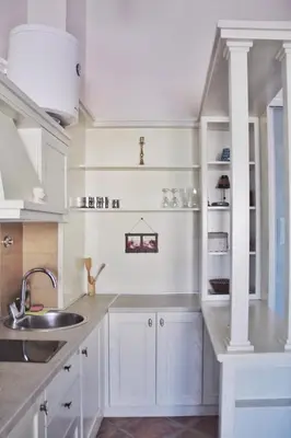 a kitchen with white cabinets and a sink at Lux M & A Apartments in Budva