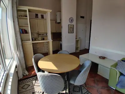 a kitchen with a wooden table and chairs at Lux M & A Apartments in Budva