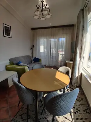 a living room with a table and chairs and a couch at Lux M & A Apartments in Budva