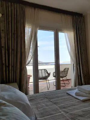 a bedroom with a bed and a view of a balcony at Lux M & A Apartments in Budva