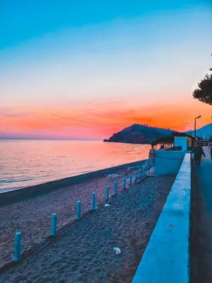 a beach with a sunset in the background at IN Villa Guesthouse in Sutomore
