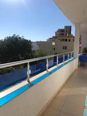 a balcony with blue and white railing on a building at Apartmani Dini in Ulcinj