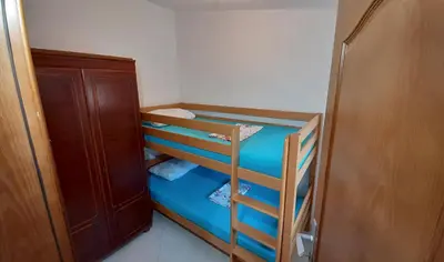 a small room with two bunk beds in it at Apartmani RAR in Dobra Voda