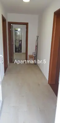 a room with a hallway with a wooden floor at Apartmani Nikmil Bar- Šusanj in Bar