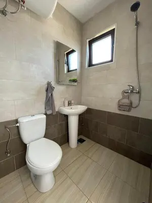 a bathroom with a toilet and a sink at OSA Holiday in Ulcinj