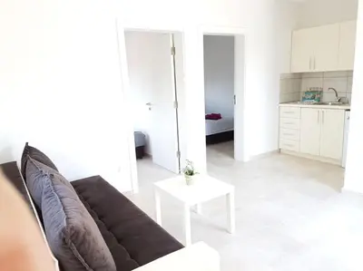 a living room with a couch and a table at OSA Holiday in Ulcinj