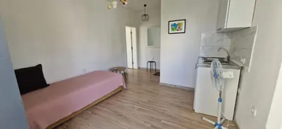 a small room with a bed and a kitchen at OSA Holiday in Ulcinj