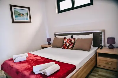 a bedroom with a large bed with two pillows at Casa Bianca & Spa in Ulcinj
