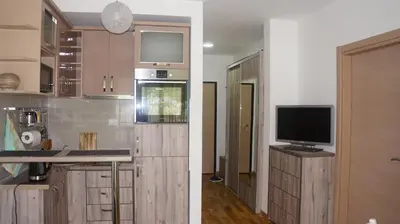 a kitchen with a tv on top of a counter at Apartments LORA Bokeljske brigade in Budva
