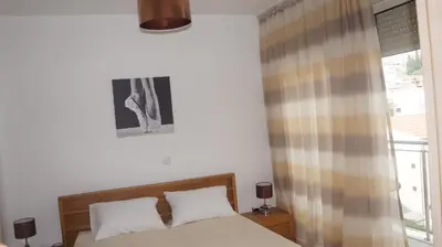 a bedroom with a bed and a window at Apartments LORA Bokeljske brigade in Budva