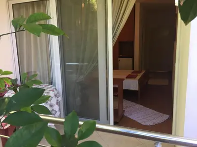 a sliding glass door with a view of a room at Tina Rooms in Ulcinj
