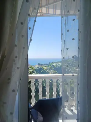 a room with a window with a view of the ocean at Tina Rooms in Ulcinj