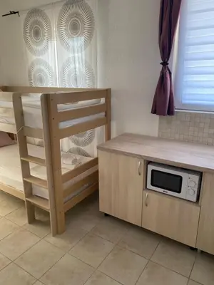 a kitchen with a bunk bed and a microwave at Apartment Tijana in Bar