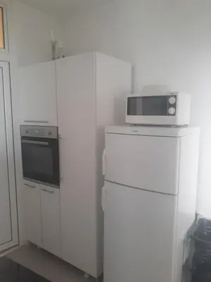 a kitchen with a microwave on top of a refrigerator at Apartment Tijana in Bar