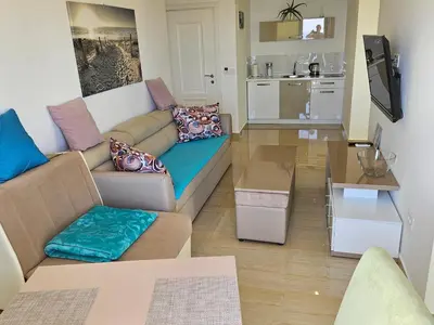 a living room with a couch and a table at Apartments D'Hermes in Ulcinj