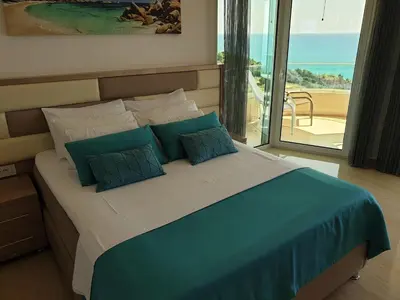 a bedroom with a bed with a view of the ocean at Apartments D'Hermes in Ulcinj
