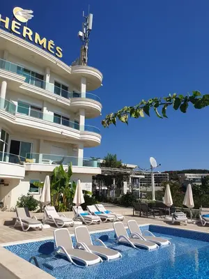 a hotel with lounge chairs and a swimming pool at Apartments D'Hermes in Ulcinj