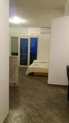 a bedroom with a bed and two windows at Apartment Vila Mirela in Krimovice