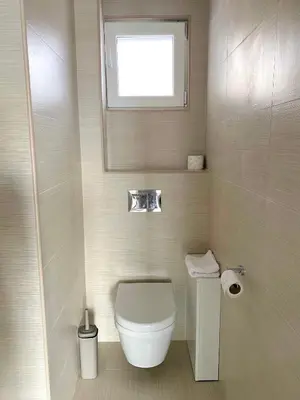 a small bathroom with a toilet and a window at Villa Casanego in Sutomore