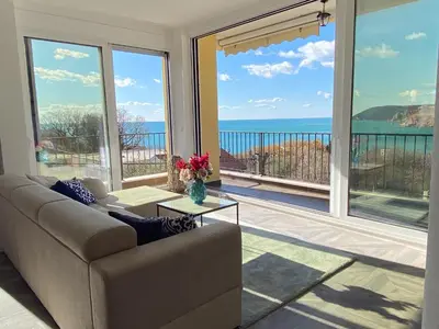 a living room with a couch and a view of the ocean at Villa Casanego in Sutomore