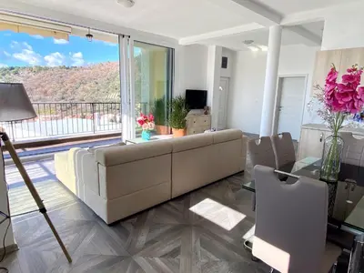 a living room with a couch and a glass table at Villa Casanego in Sutomore