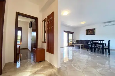 a hallway with a living room and a dining room at ViLena Apartmani in Tivat