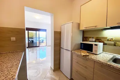 a kitchen with a refrigerator and a microwave at ViLena Apartmani in Tivat