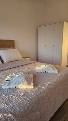 a bedroom with two beds with white cabinets at Apartments Radoman in Ulcinj